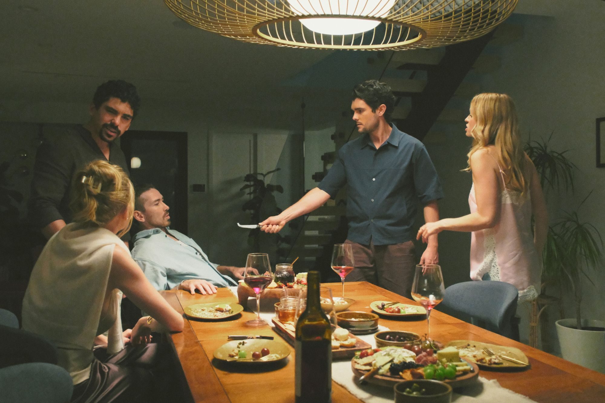A tense candlelit dinner scene from Conspiracy Theory